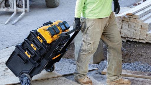 Man rolling the 4-Port Fast Charger down the sidewalk.