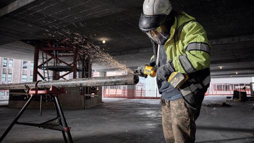 Man using FLEXVOLT 60V MAX grinder to grind steel