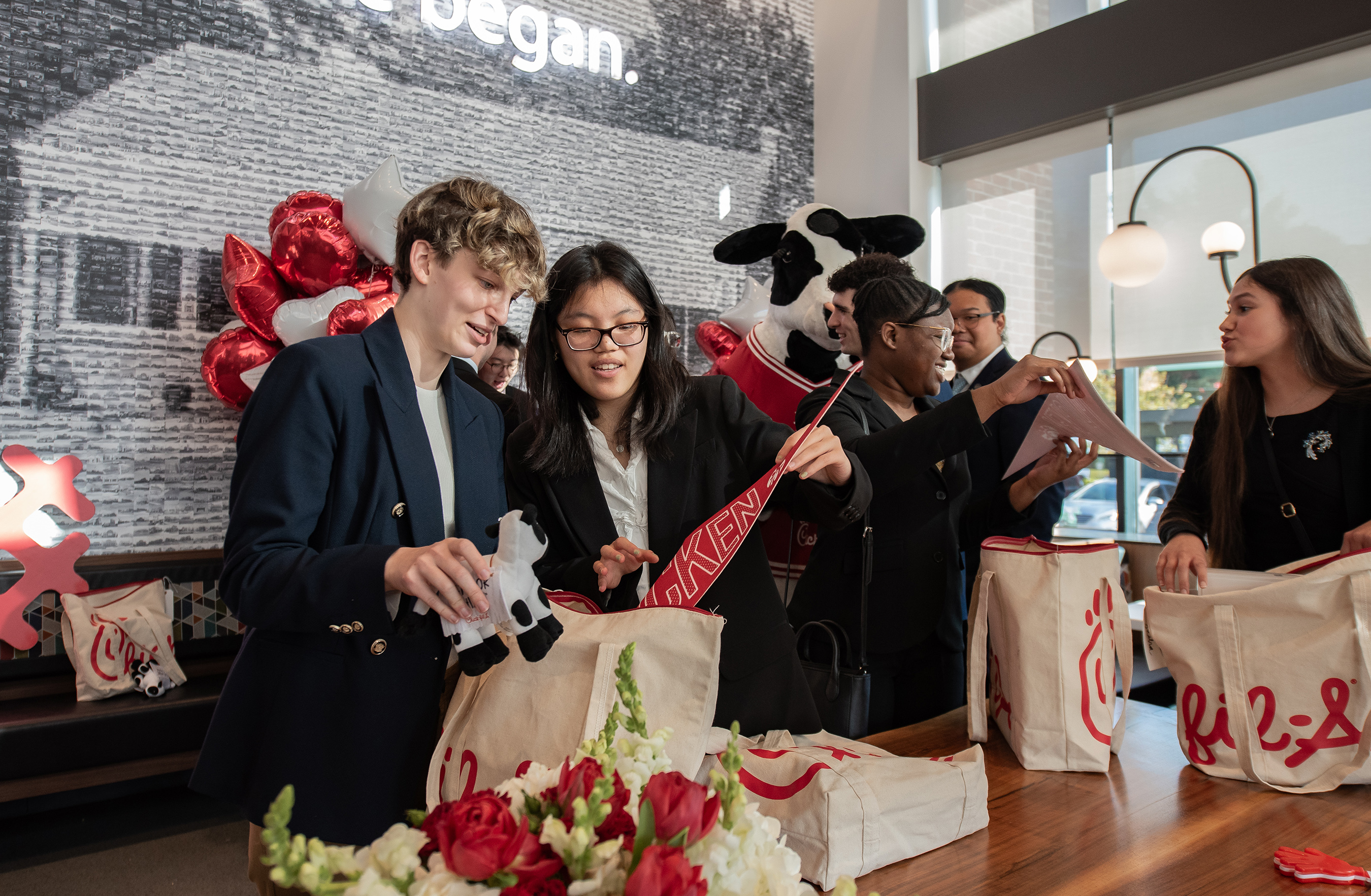 Chick-fil-A Community Scholars recipients Jensen Coonradt and Merry Wang at the scholarship reveal surprise at Chick-fil-A Dwarf House in Hapeville, Ga.