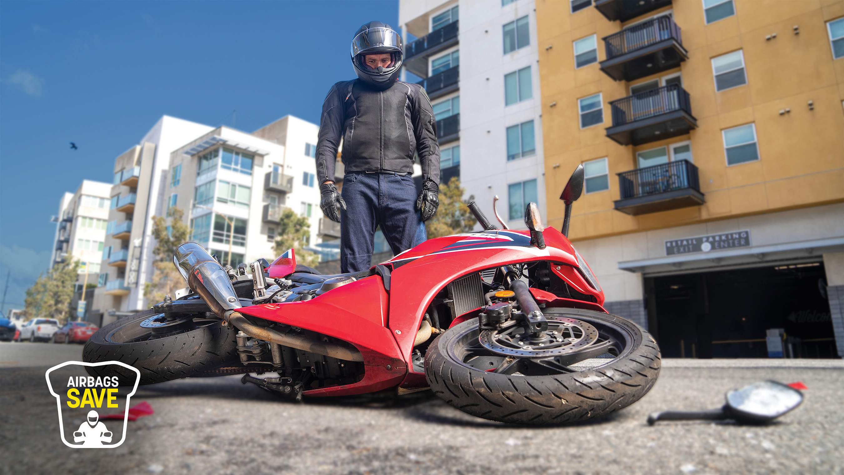 Standing man looking at crashed motorcycle